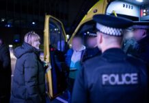 Man being arrested in front of police van