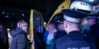 Man being arrested in front of police van