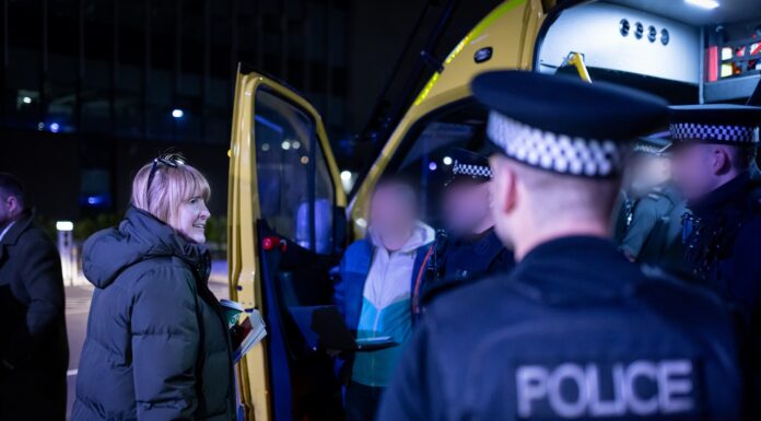 Man being arrested in front of police van